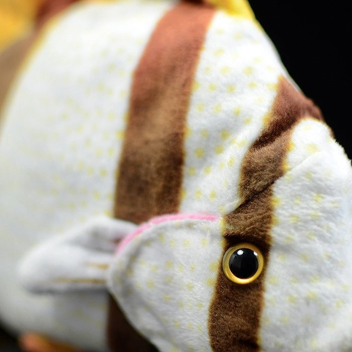 Close-up of the body and eye of realistic Four-banded Butterflyfish plush with detailed coloring