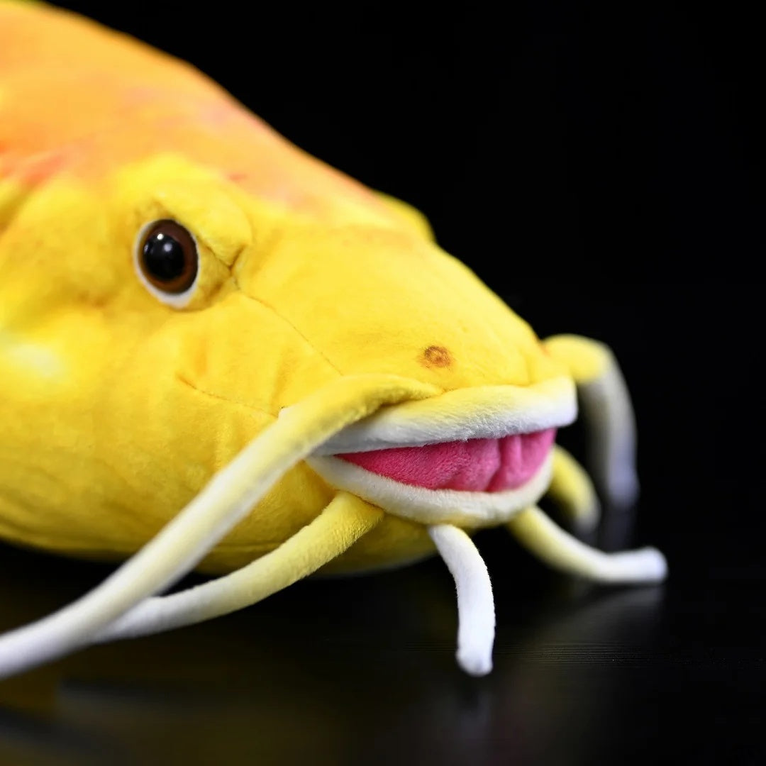 Close-up view of Golden Redtail Catfish Plush's head by SoftDaysLab®, highlighting realistic whiskers and vibrant face