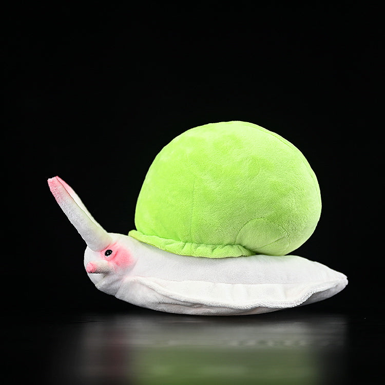 Side view of Leptopoma nitidum snail plush, featuring a green spiral shell and pink accents by SoftDaysLab
