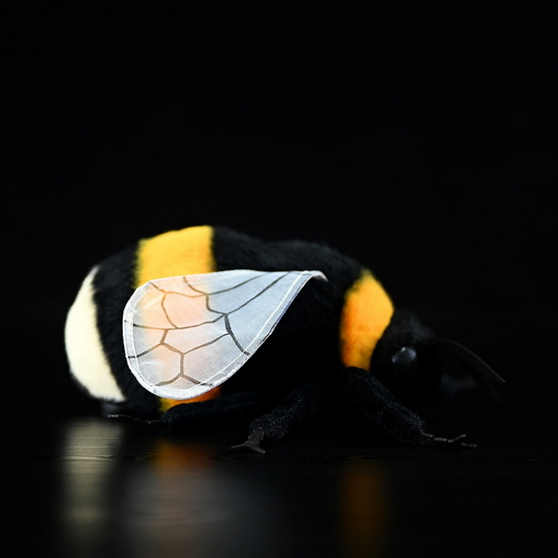 Side view of a realistic bumblebee plush toy with soft fabric, transparent wings, and vibrant colors by SoftDaysLab