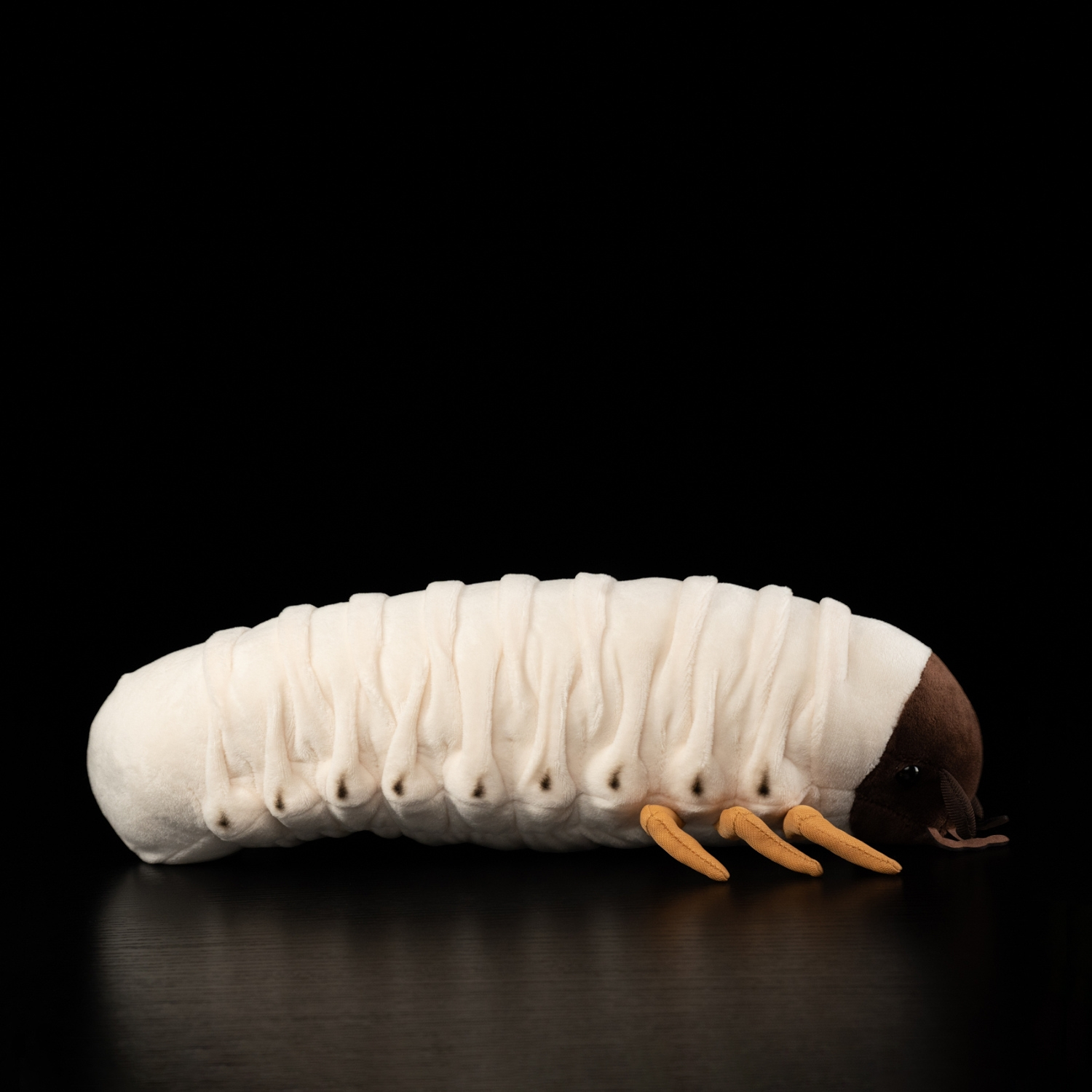 Side view of a white grub plush toy, featuring a lifelike segmented body and soft texture by SoftDaysLab