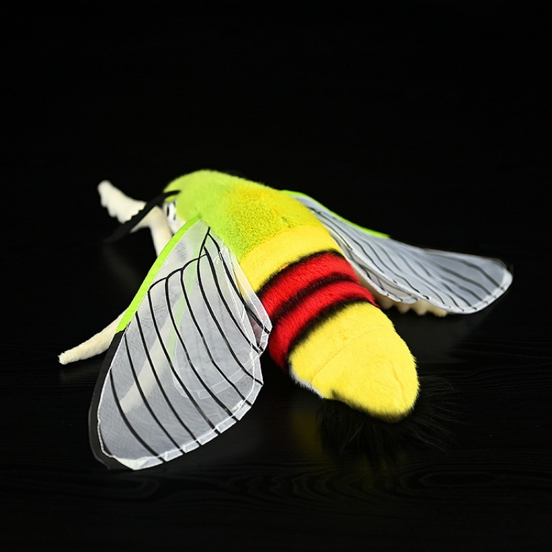 Profile view of a coffee bee hawkmoth plush, showcasing its lifelike legs and colorful design by SoftDaysLab