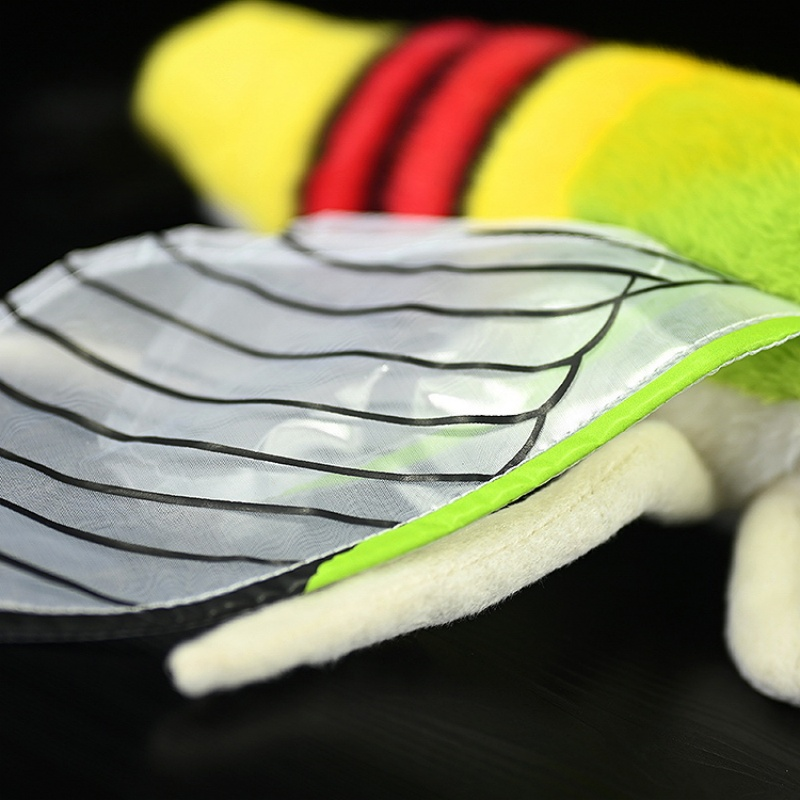 Detailed view of the realistic translucent wings of a coffee bee hawkmoth plush toy with black stripes