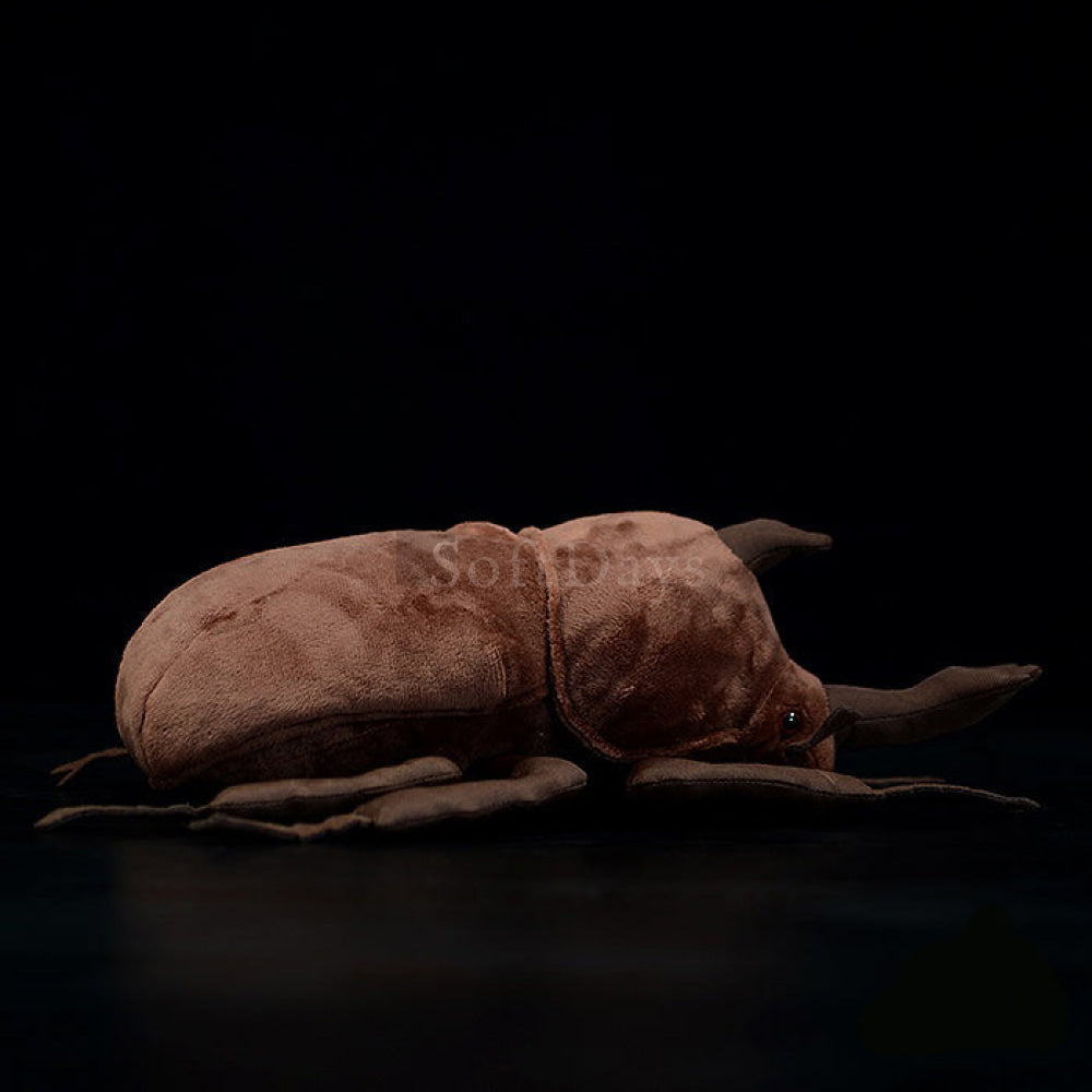 Profile view of a Japanese rhinoceros beetle plush, highlighting its soft, brown texture and realistic legs by SoftDaysLab