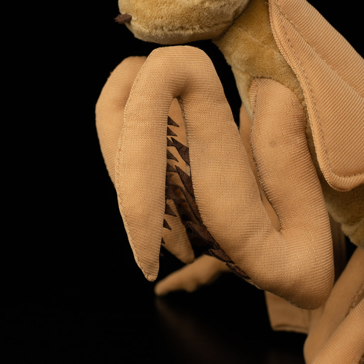 Detailed view of Dead Leaf Mantis plush legs by SoftDaysLab®, featuring lifelike mantis anatomy
