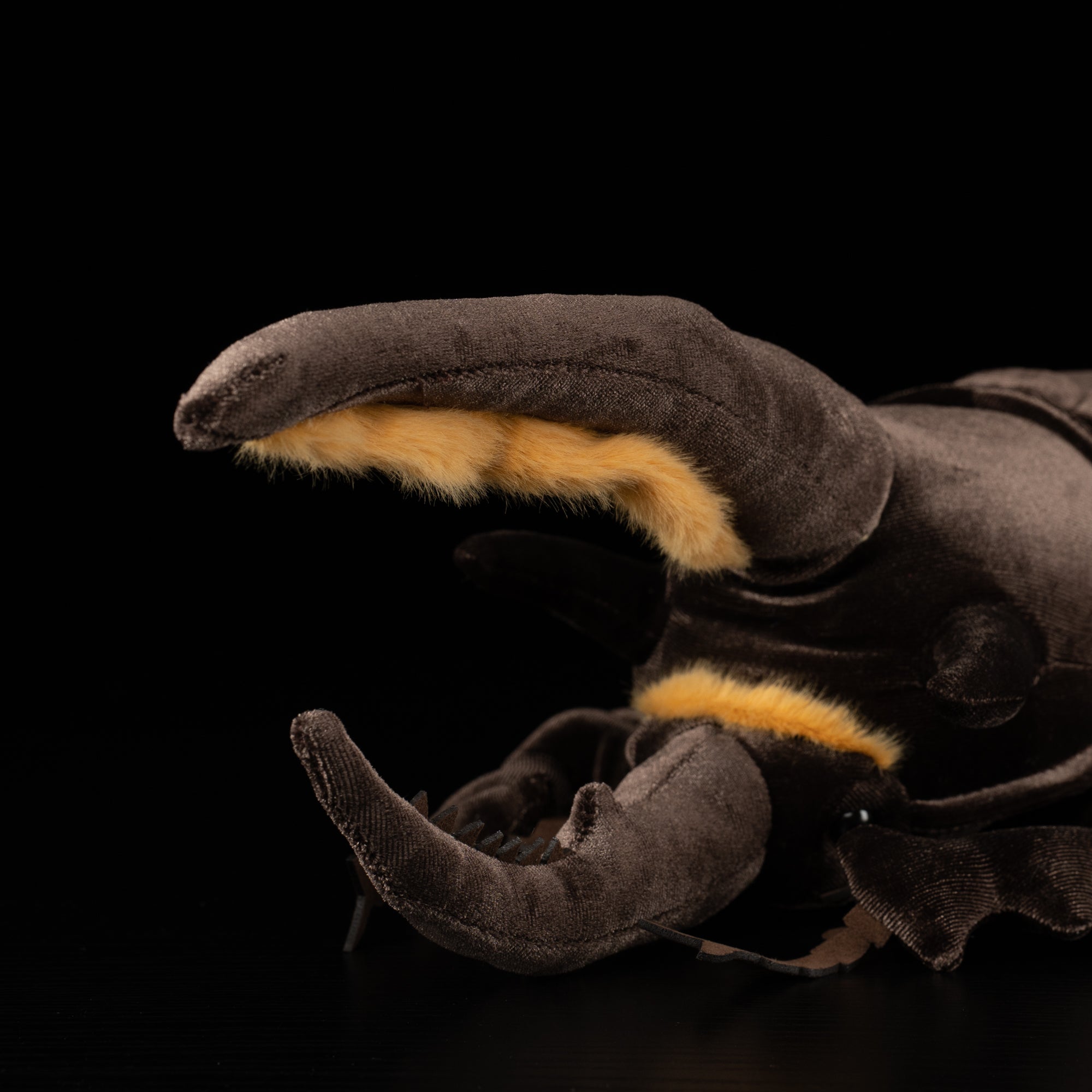 Close-up of Neptune Hercules beetle plush's soft, detailed horns with yellow accents for realism