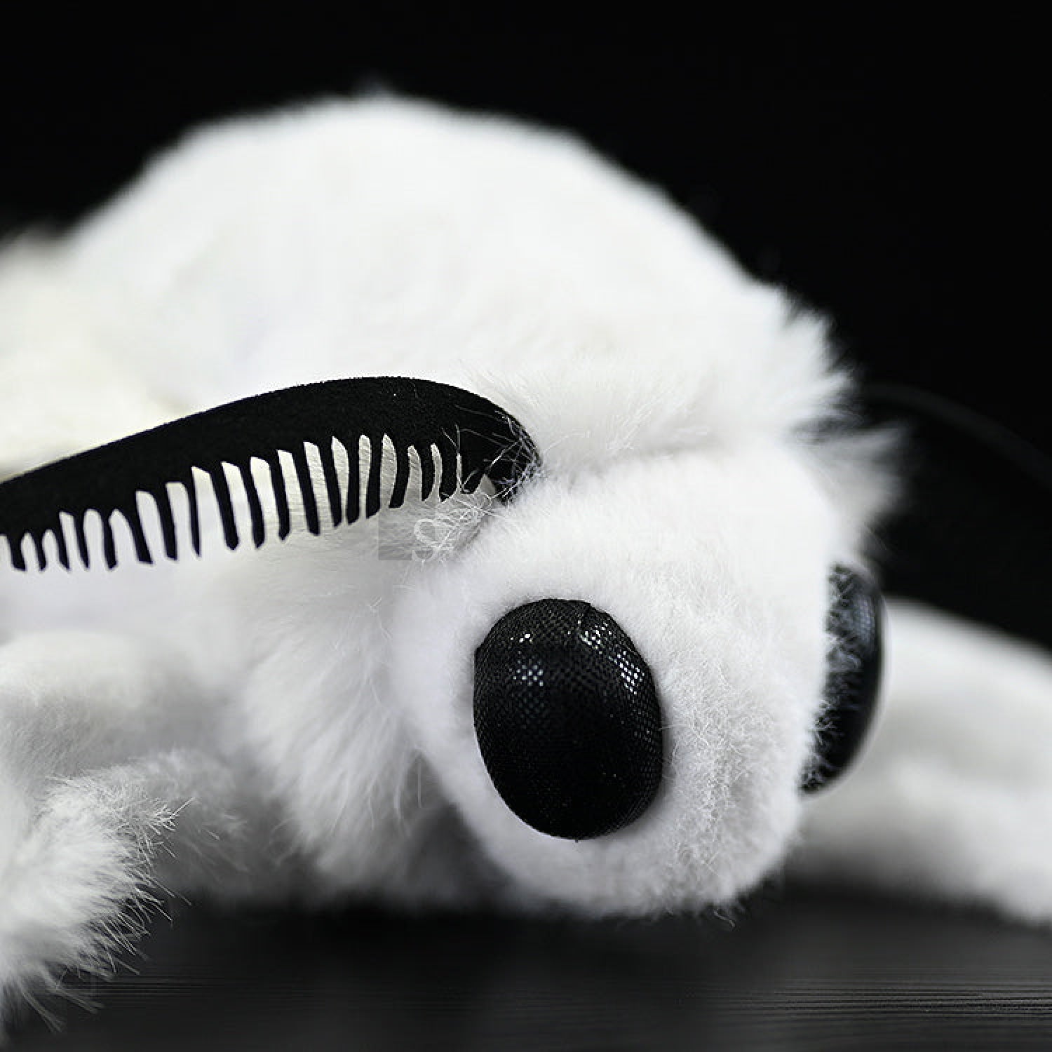 Detailed close-up of Fall Webworm Moth plush's head, featuring realistic antennae and fluffy texture