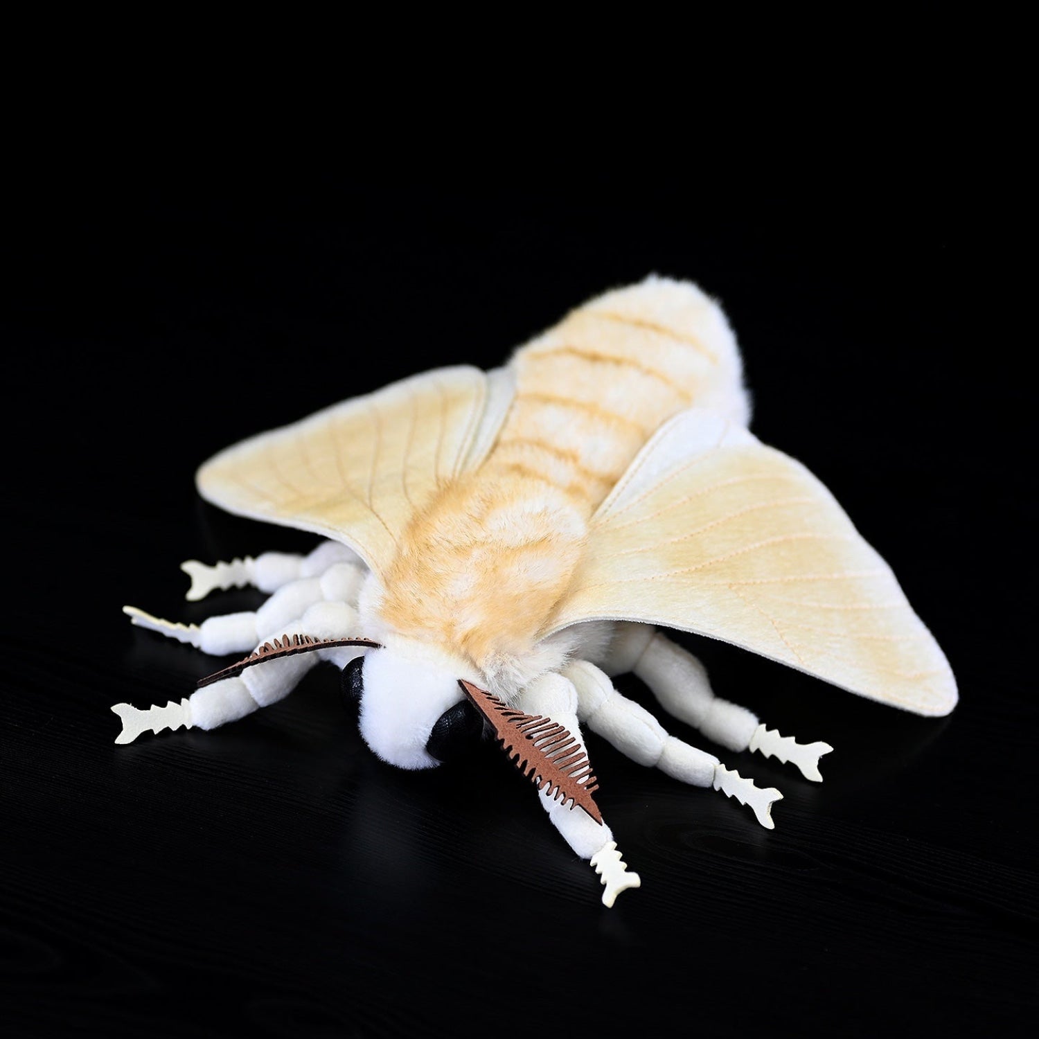Top-down view of Domestic Silk Moth plush emphasizing its soft, striped body and lifelike proportions