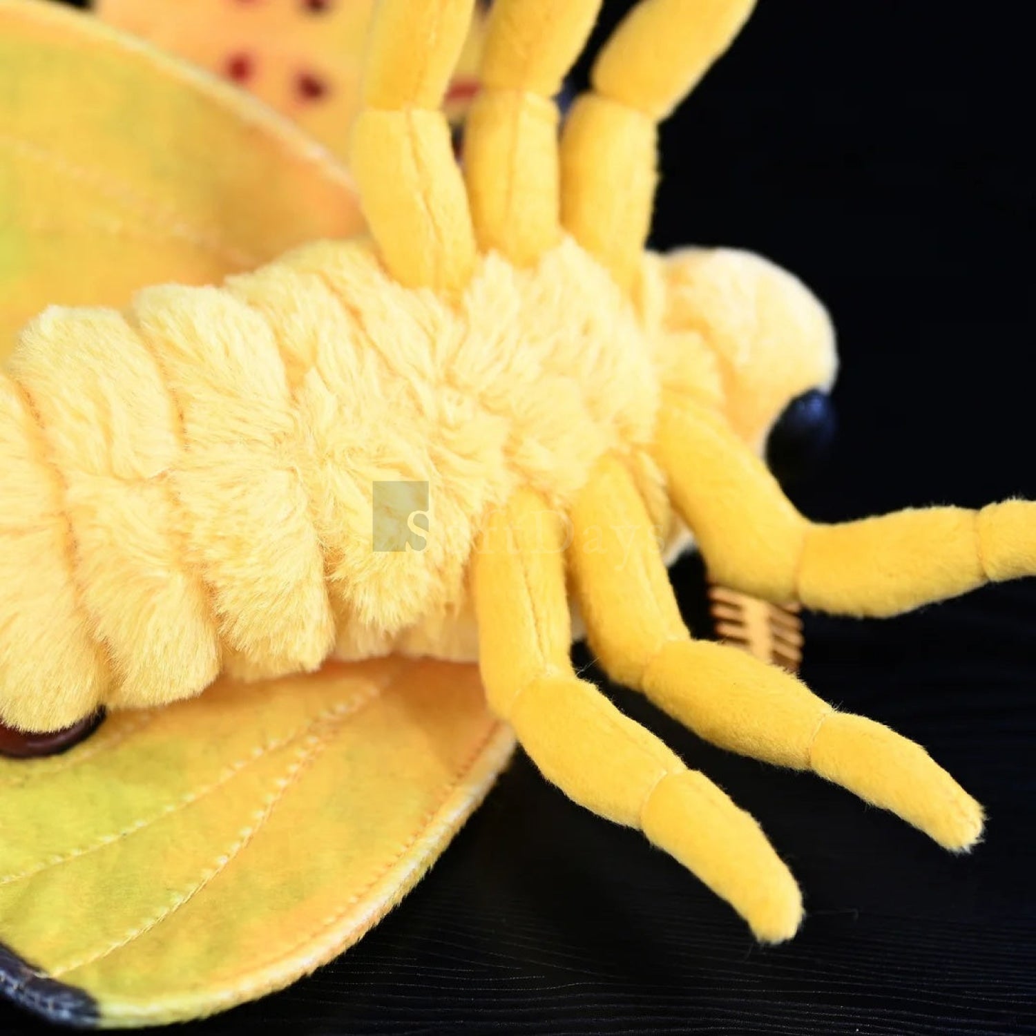 Detailed view of comet moth plush underside, showcasing its soft body and realistic legs