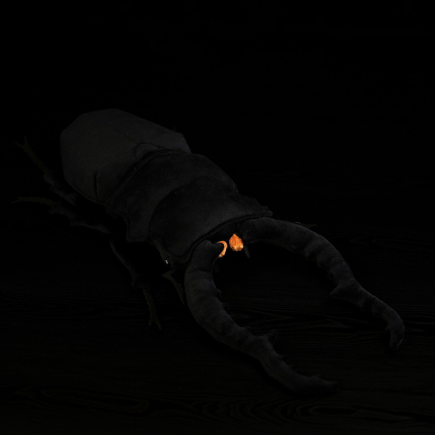 Top angle of the Giraffe Stag Beetle plush toy shows its accurate body and prominent mandibles