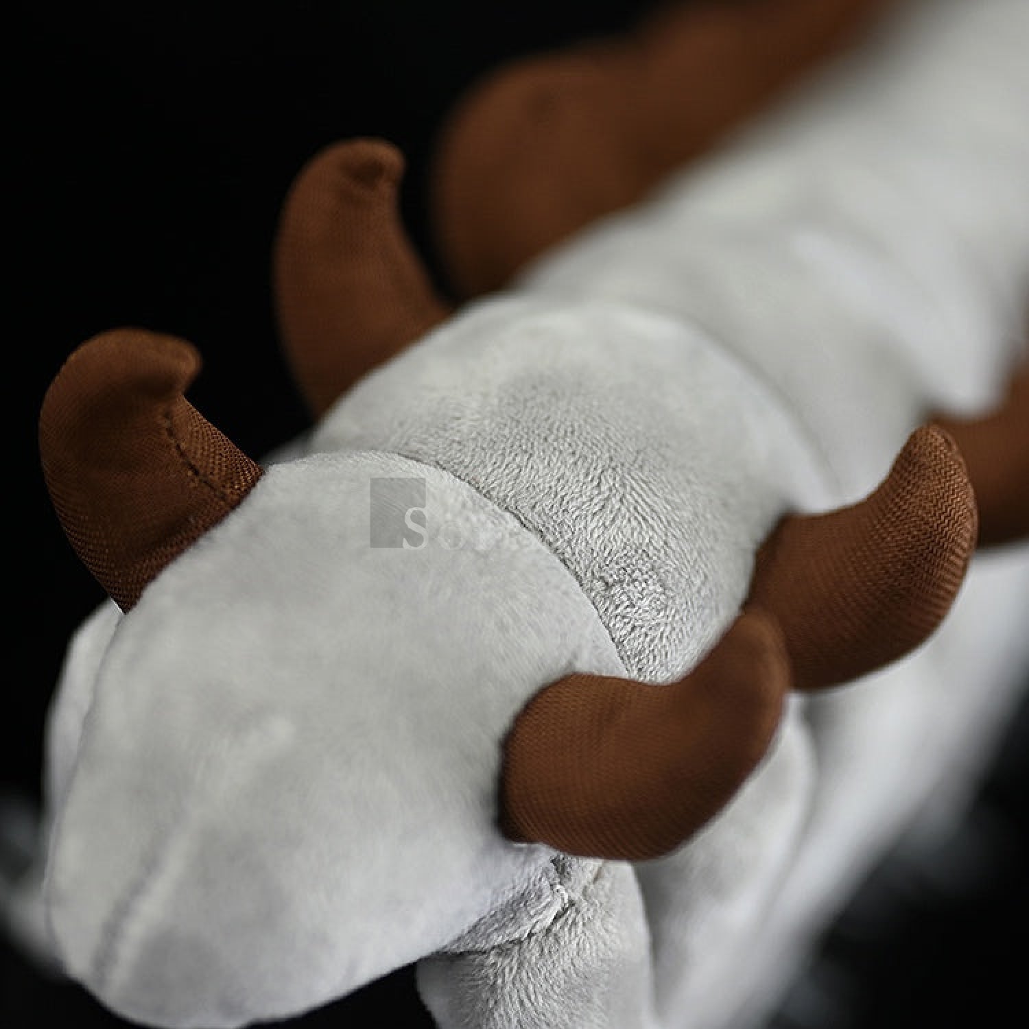 Close-up of the Onychodictyon plush toy’s back, highlighting the soft texture and lifelike spike details