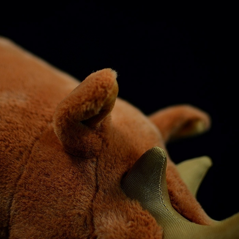 Close-up of Arsinoitherium toy head, focusing on ears and horns with fine craftsmanship