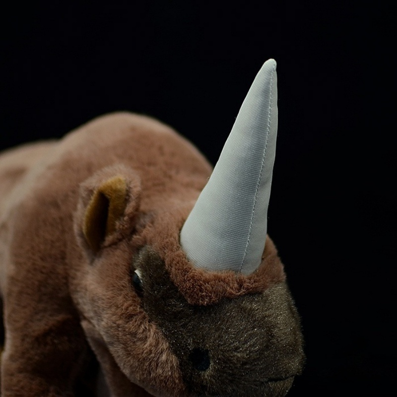 Close-up of Elasmotherium plush toy's head with a prominent horn and finely crafted ears