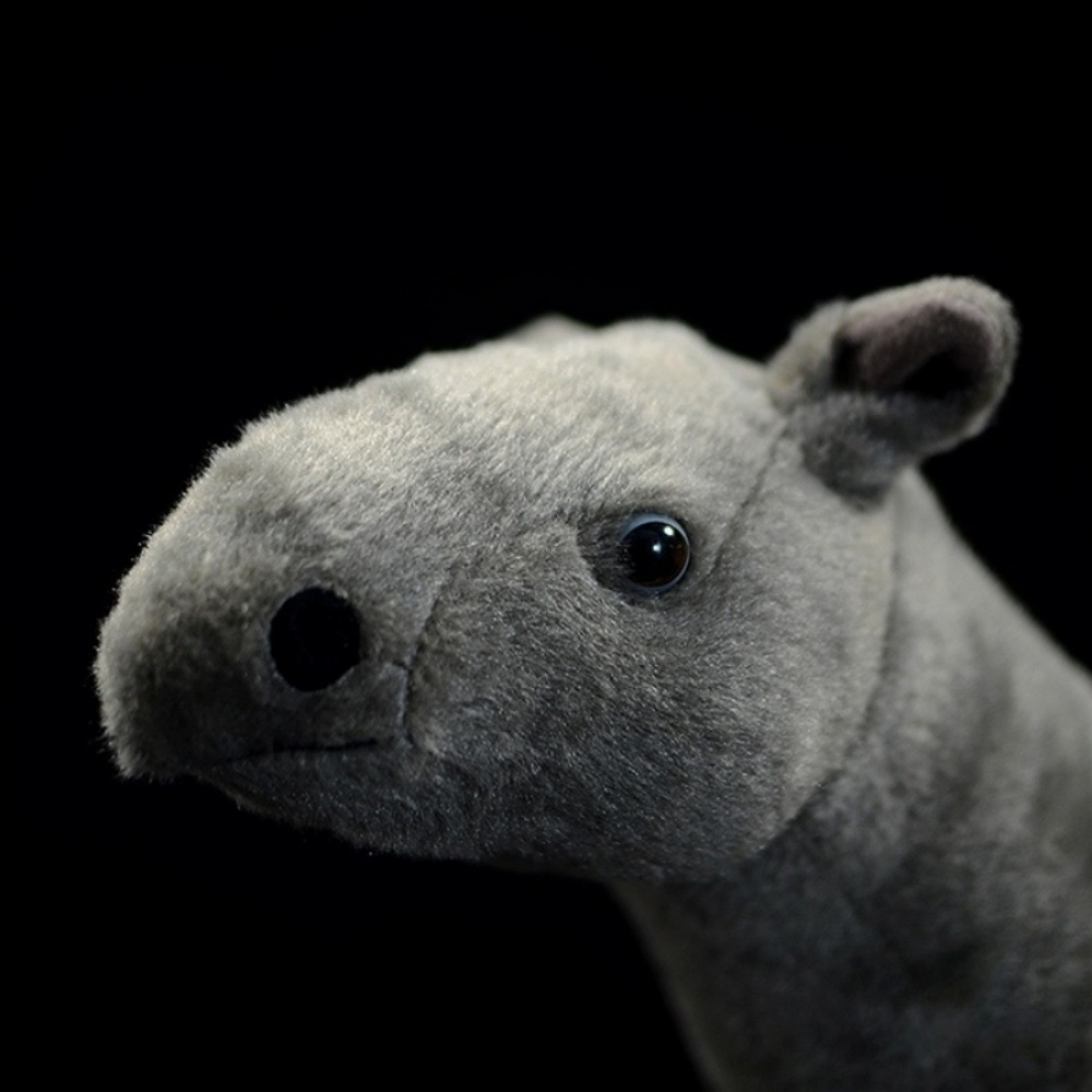 Close-up of Paraceratherium plush toy's head, showing its detailed nose and lifelike eyes