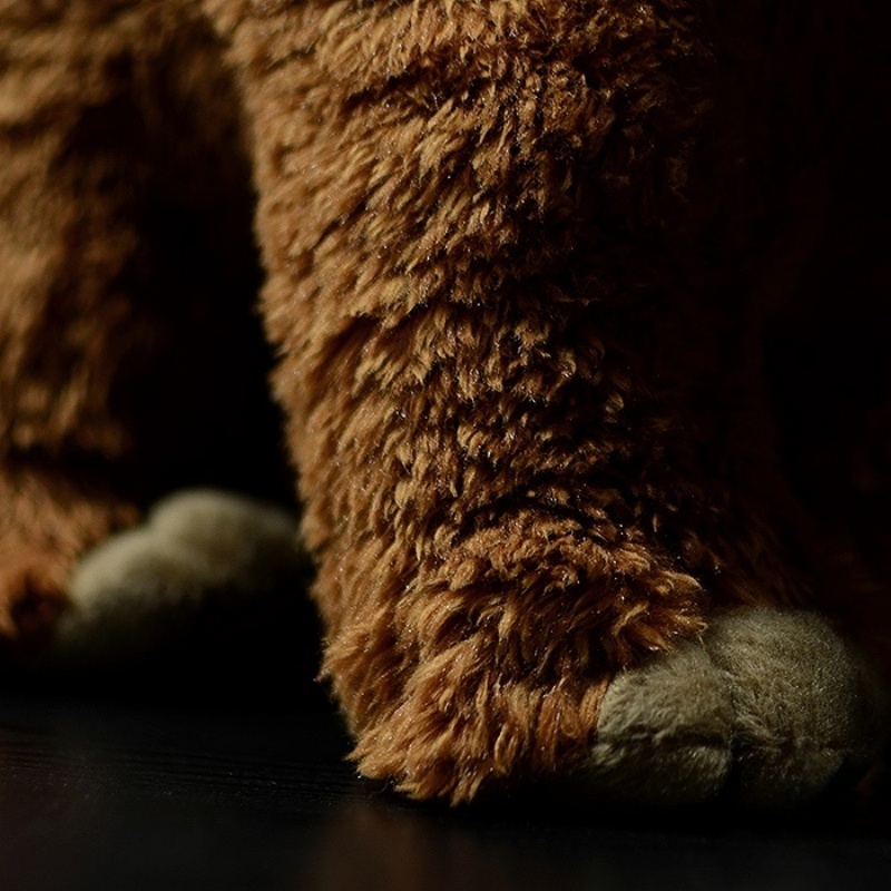 Close-up of woolly mammoth plush toy’s textured fur and realistic feet for a lifelike appearance