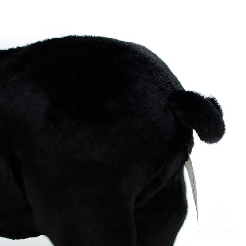 Focused shot of black pig plush toy’s curled tail, adding charm to its lifelike design