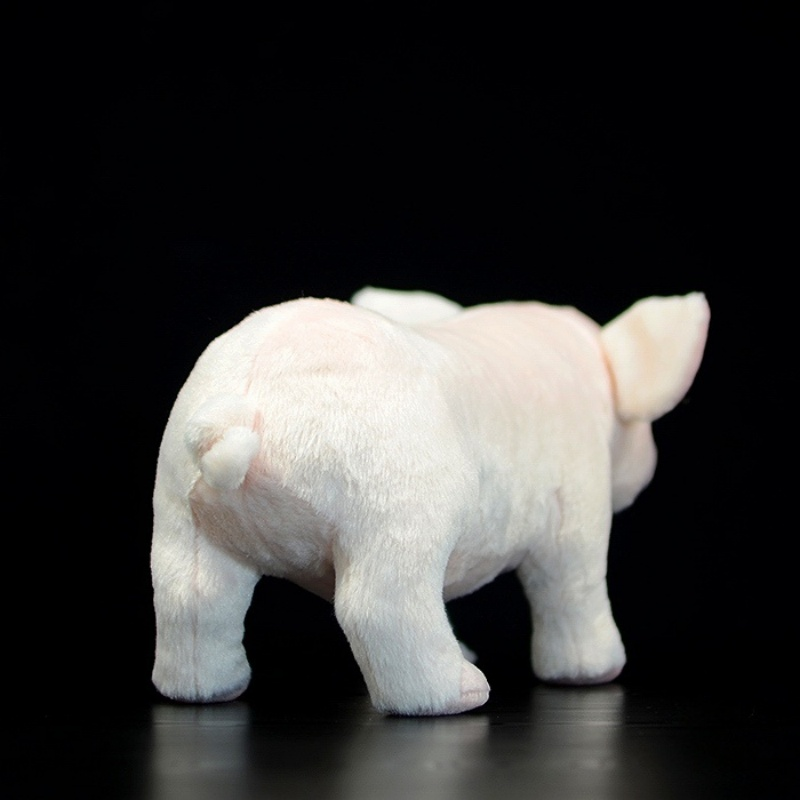 Rear view of a soft white pig plush toy showcasing its curled tail and realistic texture