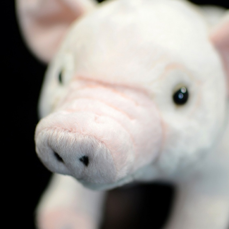 Close-up of the pig plush’s snout, showing realistic stitching and soft texture