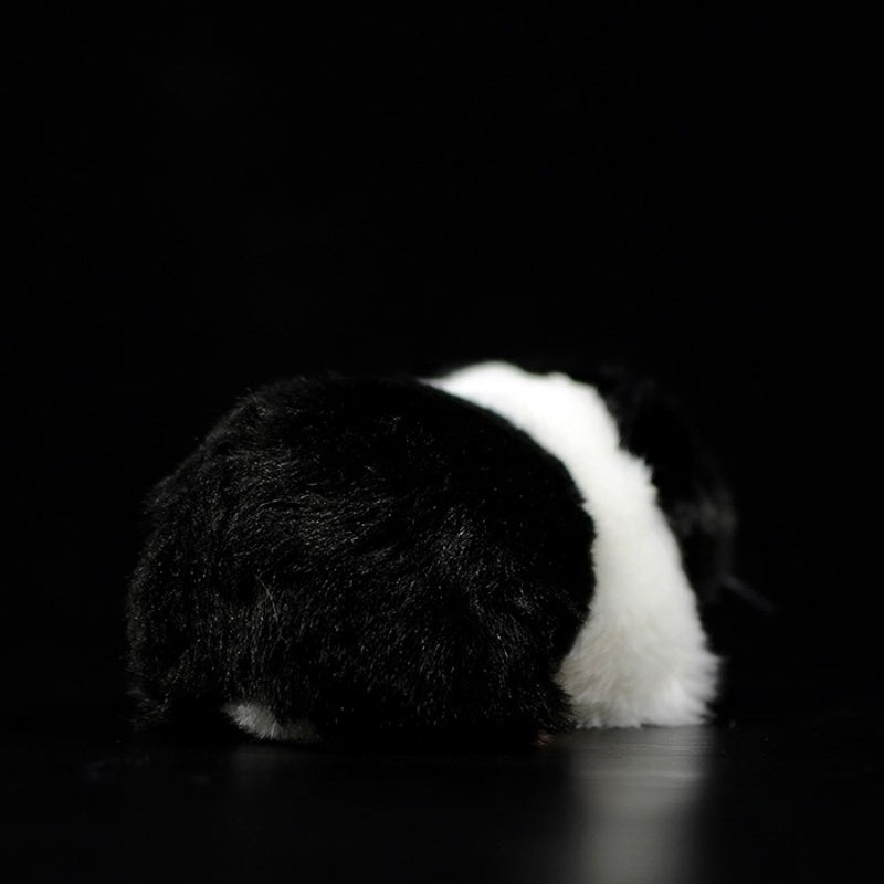 Rear view of a black and white guinea pig plush toy highlighting its soft, realistic fur by SoftDaysLab