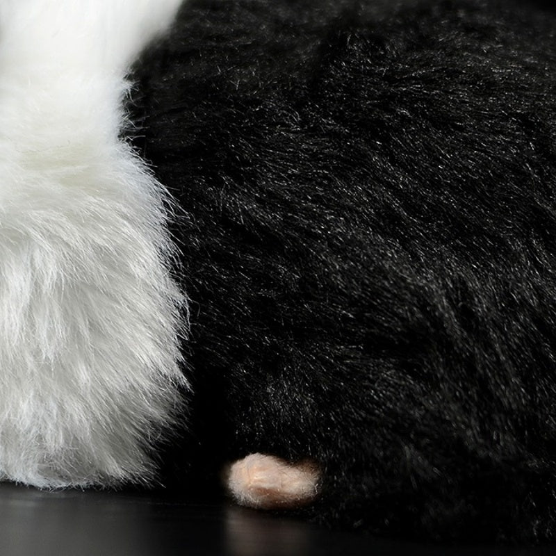 Detailed close-up of the guinea pig plush toy’s soft black and white fur and tiny paw by SoftDaysLab