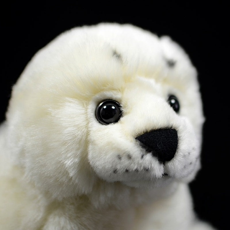 Close-up of a white seal pup plush toy’s adorable face with lifelike eyes and soft fur, by SoftDaysLab