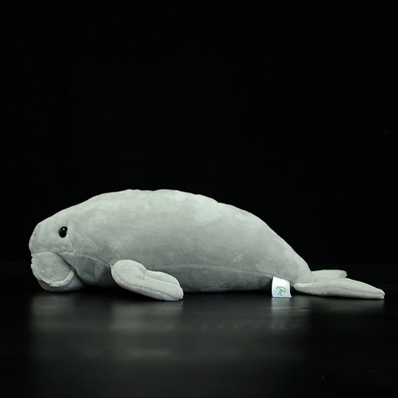 Side profile of the dugong sea cow plush toy, emphasizing its realistic fins and lifelike shape