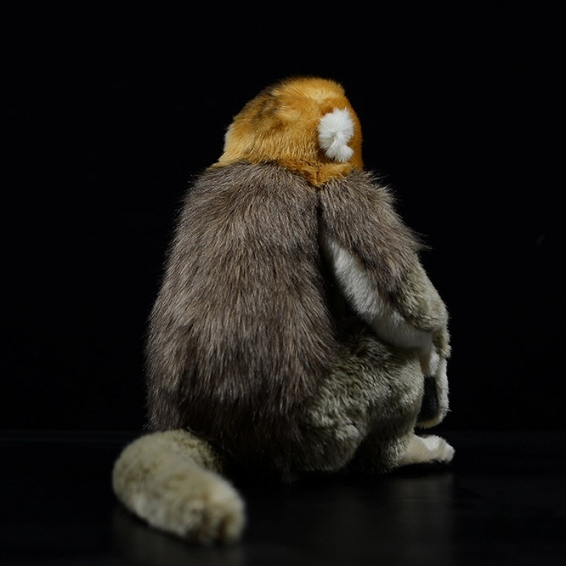 Rear view of a golden snub-nosed monkey plush toy, emphasizing its detailed fur texture and fluffy tail