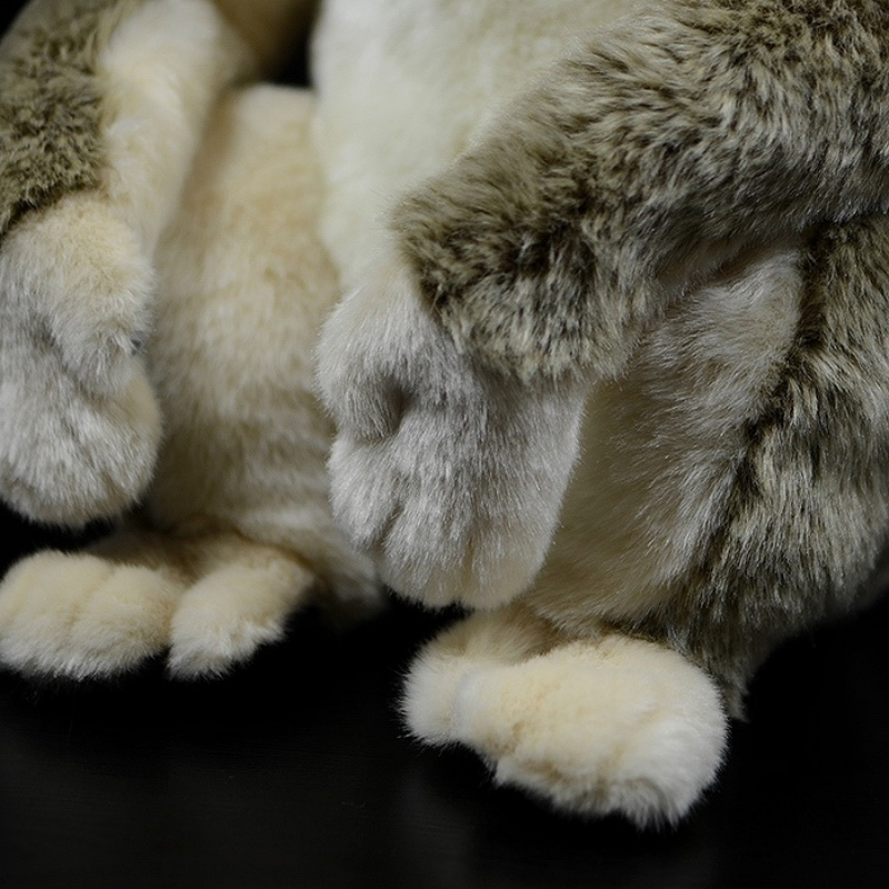 Detailed close-up of the golden snub-nosed monkey plush toy’s soft paws and realistic fur texture by SoftDaysLab