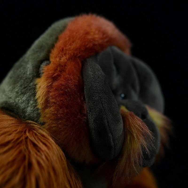 Side close-up of orangutan plush toy’s fur and ear detail, showcasing its realistic texture