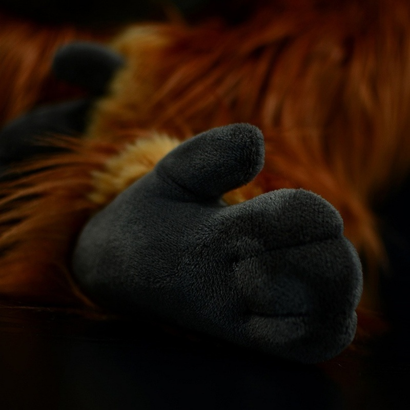 Close-up of orangutan plush toy’s realistic hand, featuring soft and detailed design