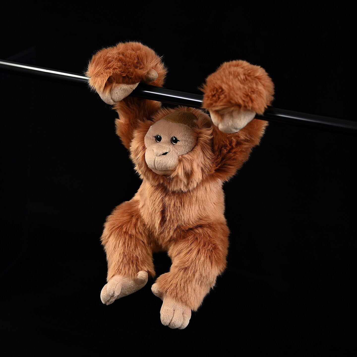 Realistic orangutan plush toy hanging, perfect for animal-themed decor or cuddly companionship