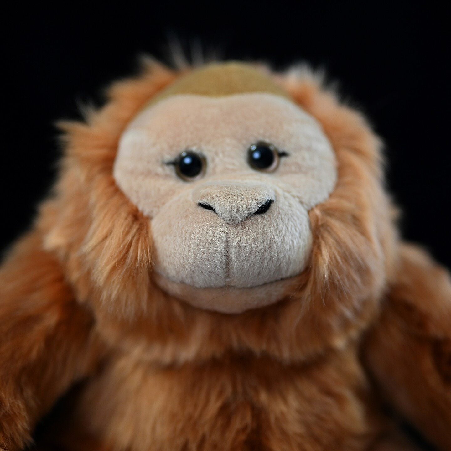 Sitting orangutan plush toy with lifelike design and soft fur, ideal for kids and collectors