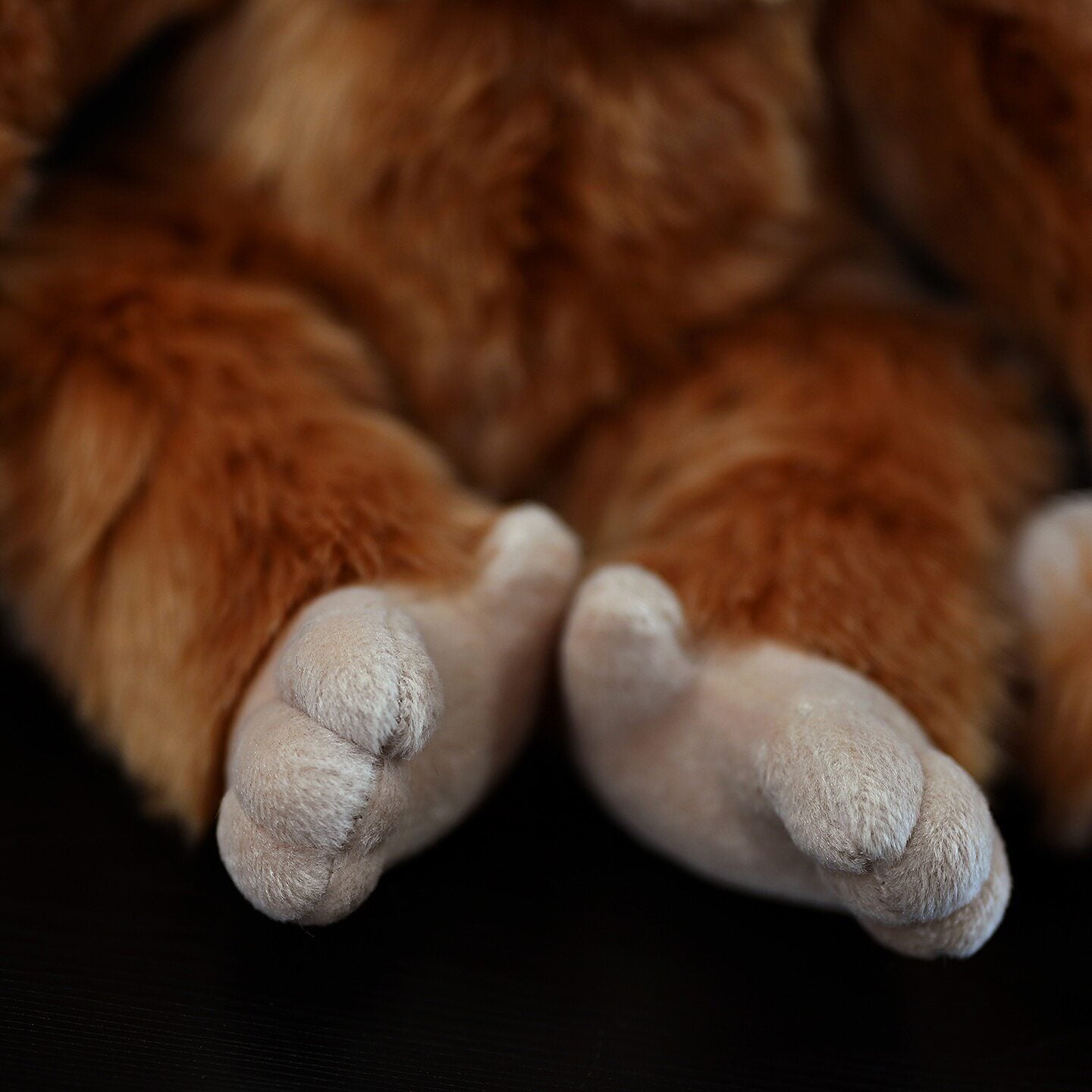 Orangutan plush toy feet close-up, designed with soft textures and lifelike details perfect for cuddling