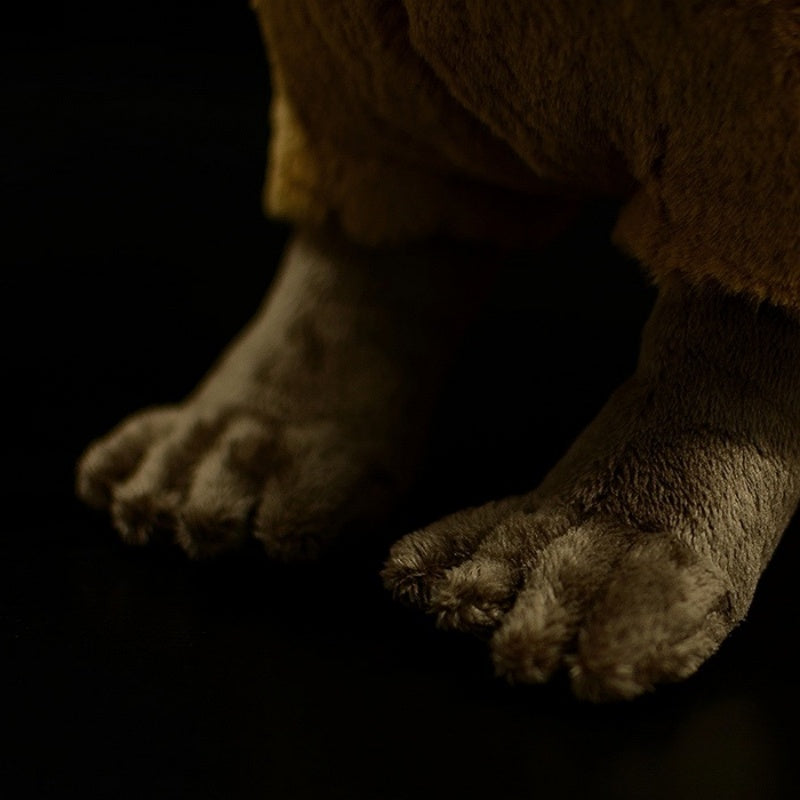 Close-up of the detailed paws of a realistic capybara plush toy with a soft texture