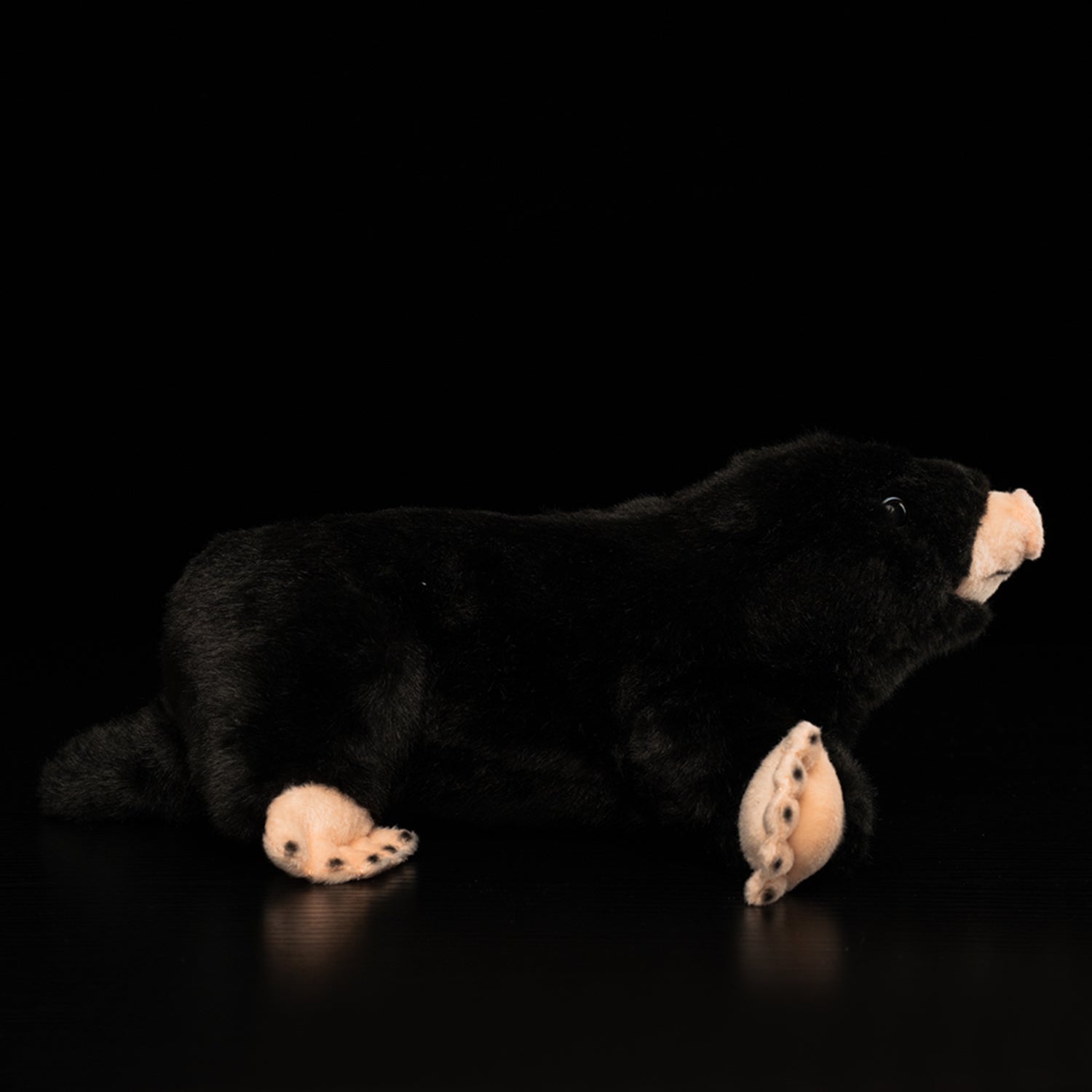 Side profile of a mole plush toy, showing realistic details and soft, cuddly texture