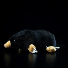 Side view of a realistic lying mole plush toy with soft black fur and detailed claws, perfect for animal lovers