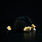 Back view of a lying mole plush toy, highlighting its soft texture and detailed tail design
