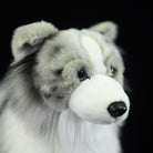 Face close-up of Blue Merle Border Collie plush toy, showing lifelike eyes and soft nose