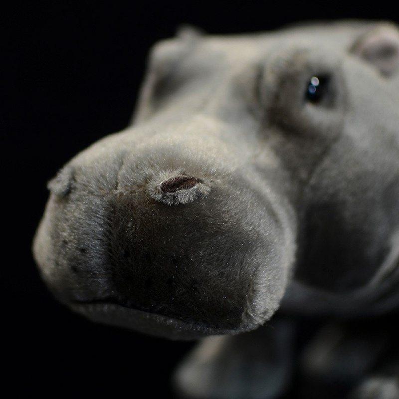 Close-up of hippo plush toy's face, showcasing realistic details and craftsmanship