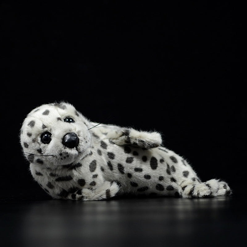 Spotted seal pup plush toy lying on its belly, showcasing lifelike spots and soft fur by SoftDaysLab