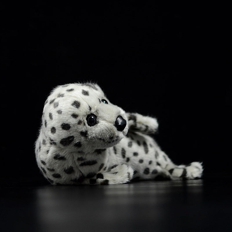 Side view of a soft spotted seal pup plush, with lifelike details and cuddly design by SoftDaysLab