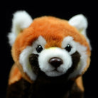 Close-up of the red panda plush toy's face, showing its lifelike expression and charming features