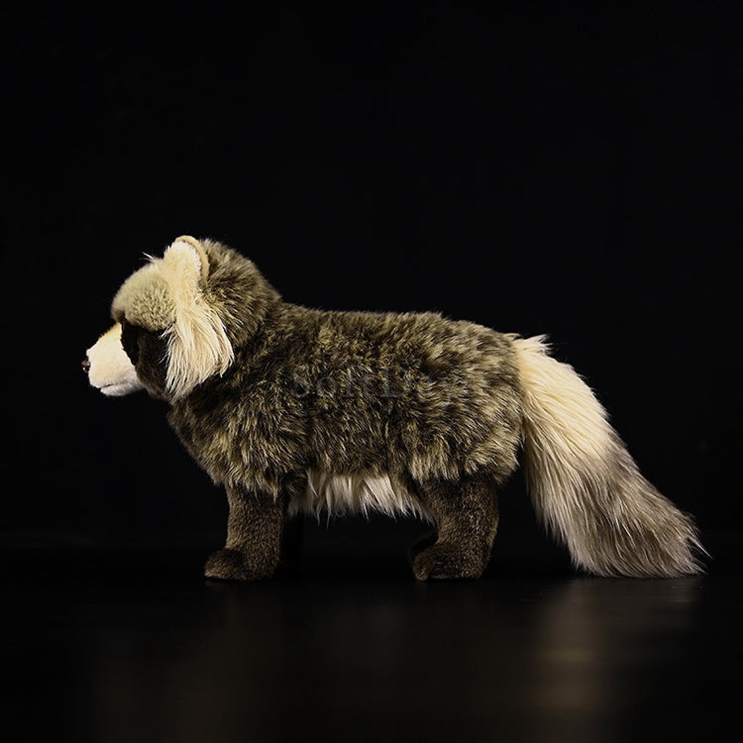 Side view of lifelike Japanese raccoon dog plush toy, highlighting realistic fur texture and bushy tail