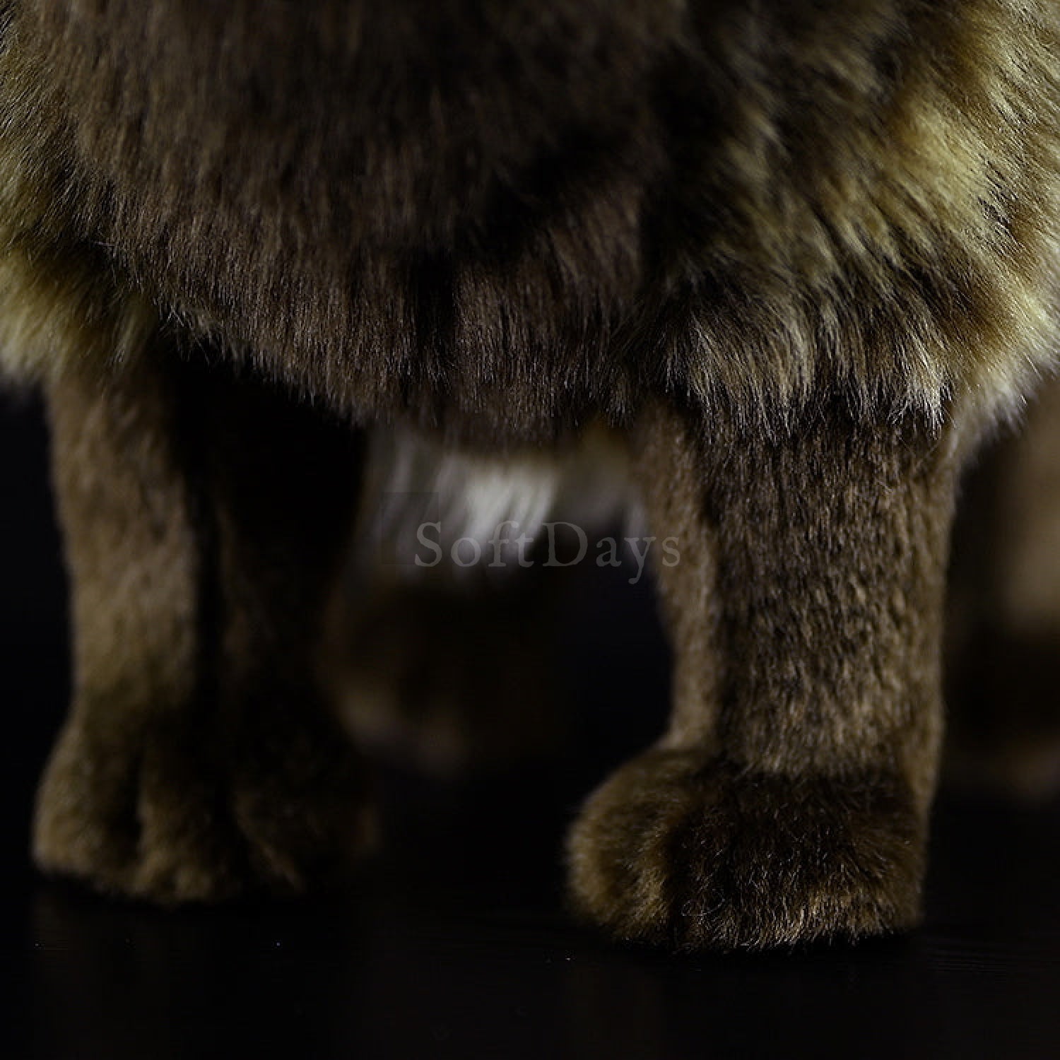 Close-up of Japanese raccoon dog plush toy’s legs, highlighting soft fur and lifelike design