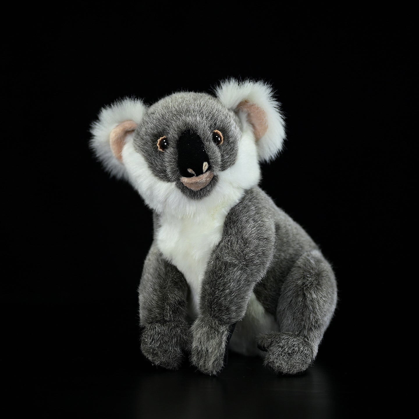 Realistic koala plush toy sitting upright, featuring soft gray fur and lifelike details