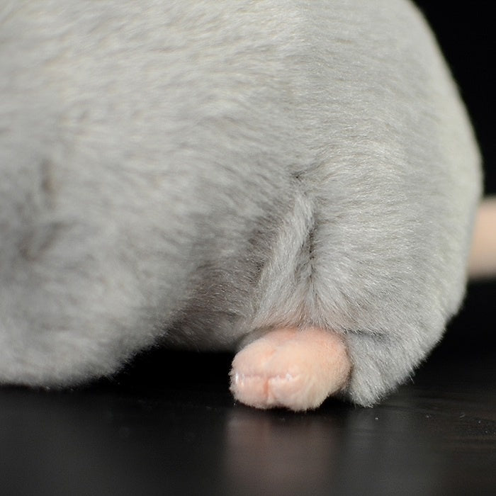 Detailed view of the grey mouse plush toy's paw, showing soft materials and lifelike design