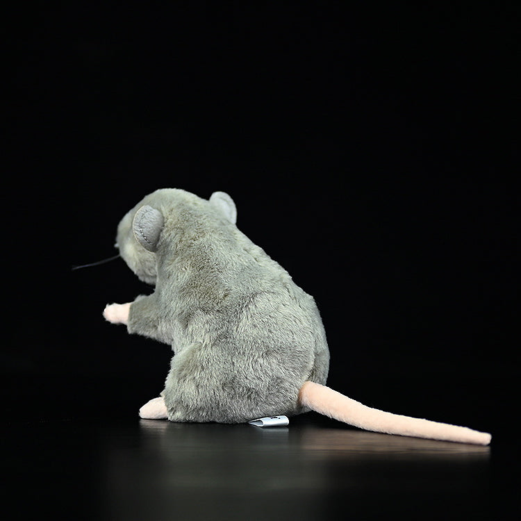 Rear side view of a standing grey mouse plush toy, featuring its detailed tail and soft texture