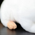 Close-up of the white lab mouse plush toy’s paw, showcasing its realistic and delicate design