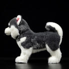 Side profile of a grey and white Alaskan Malamute plush toy showcasing its fluffy double coat