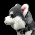 Side view of the Alaskan Malamute plush toy’s head, highlighting its upright ears and soft fur